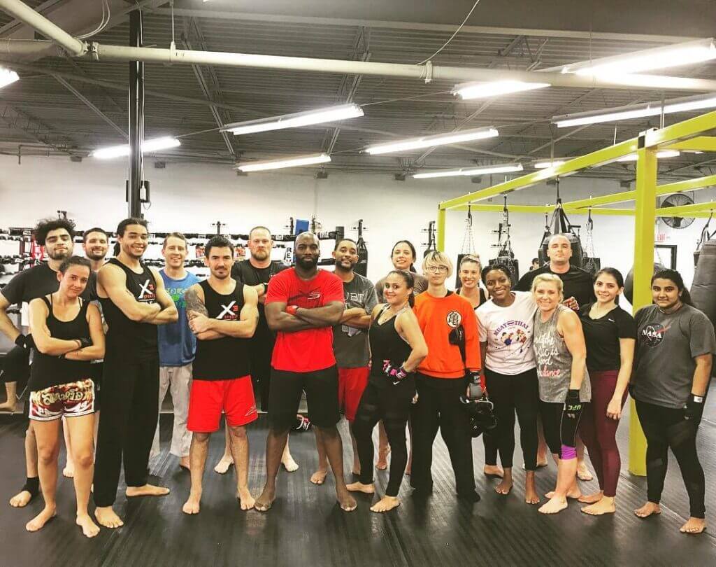 Group photo of men and women who train in kickboxing together at X3 Sports