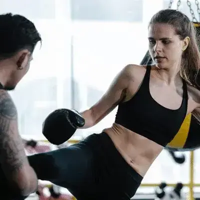Kickboxing Technique Practice Woman practicing kickboxing with a trainer in a gym
