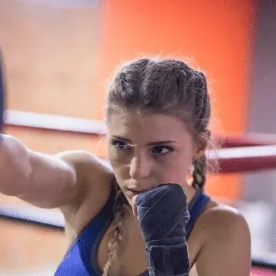 Woman Practicing Shadow Boxing in the Ring Female boxer performing shadow boxing exercises in a boxing ring