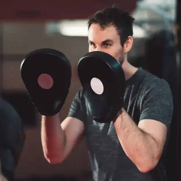 Boxing Coach Holding Mitts for a Mitt Work Training Session Beginner boxing lessons